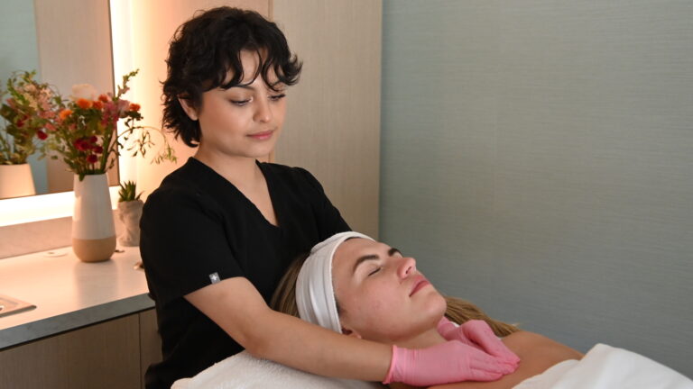 Esthetician giving facial to client
