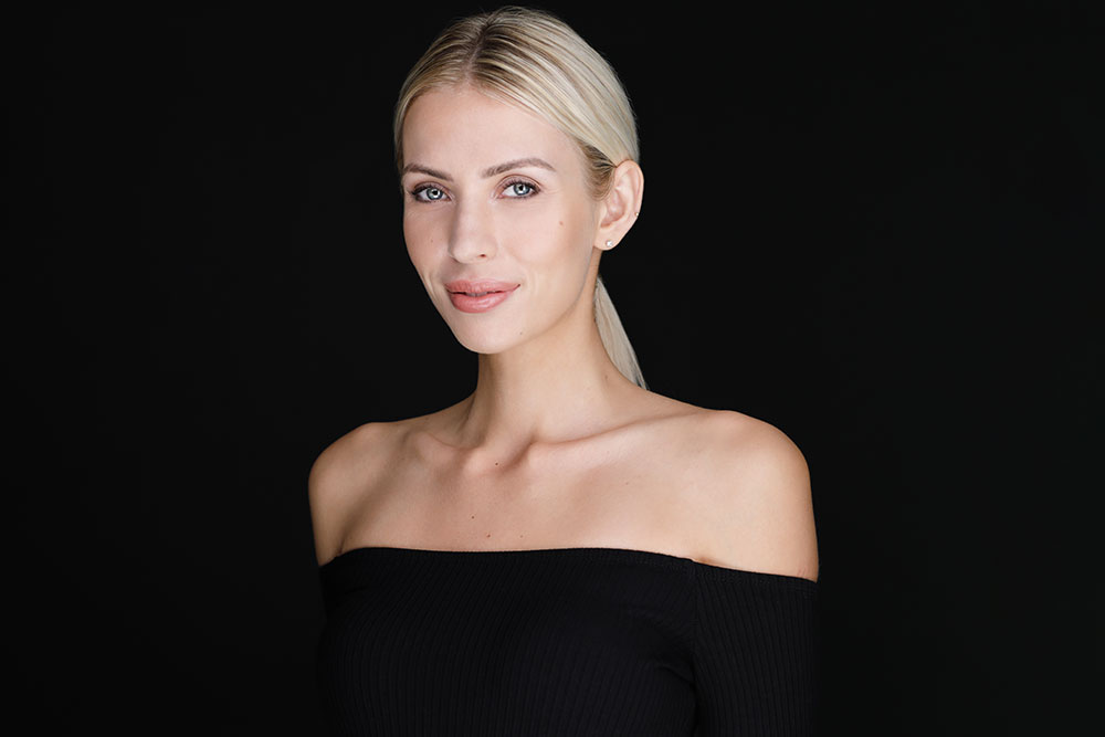 Beautiful girl posing over black background