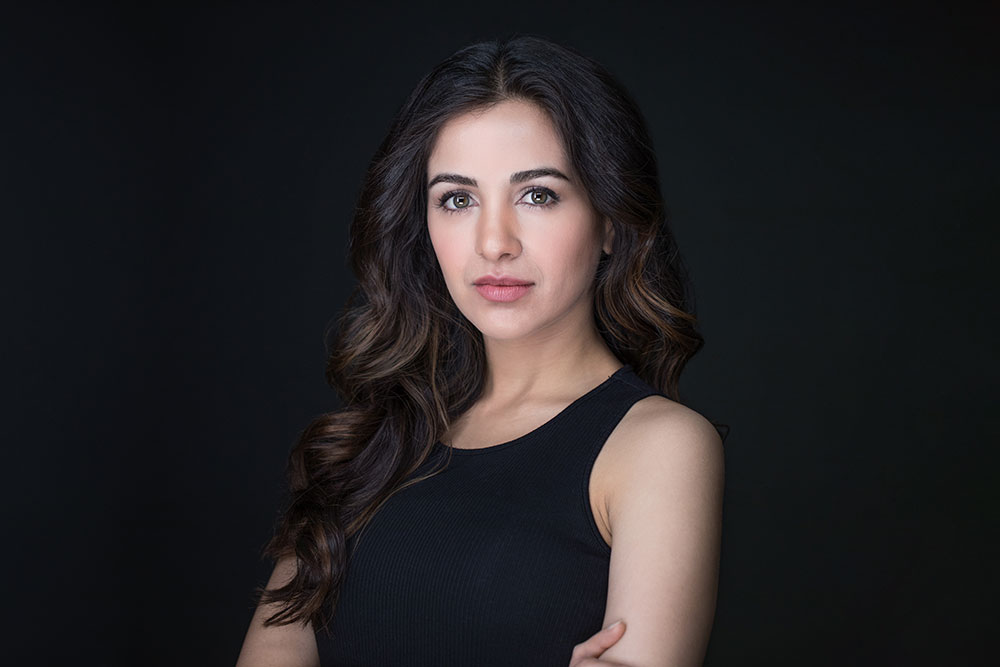 Beautiful girl posing over black background