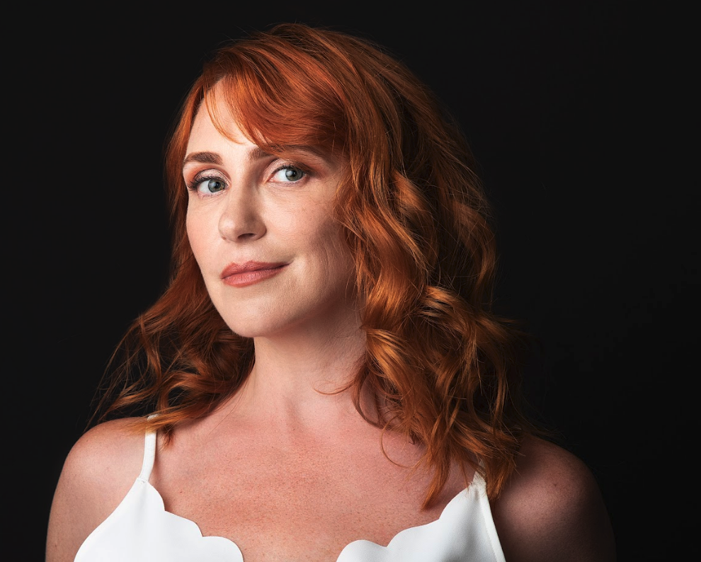 Woman with red hair smiling after facial plastic surgery in Palo Alto, CA