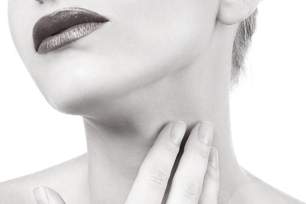 woman touching neck after Neck Treatment